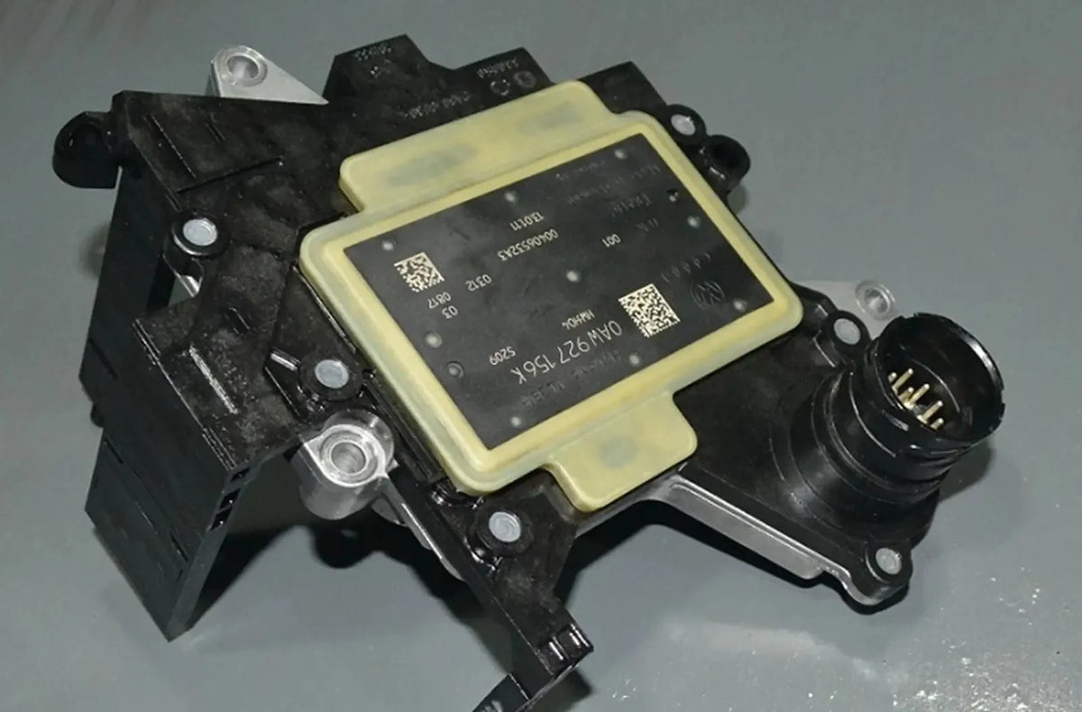 Muestra el cuadro de instrumentos digital de un vehículo moderno con el testigo amarillo de advertencia "Check Engine" iluminado junto a un mensaje explícito de servicio de "Fallo de transmisión" ("Transmission Fault").